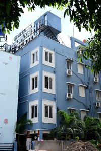 a blue building with a sign on top of it at Hotel Amaravathi Grand in Vijayawāda