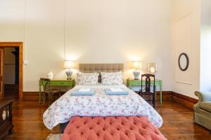 a bedroom with a large bed and two tables at La Rochelle in Montagu +61 photos