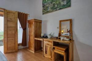 a bathroom with a wooden vanity and a mirror at The Penida Angmas View in Nusa Penida
