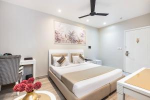 a white bedroom with a bed and a table at Skon Boutique by Orion Hotels in Delhi