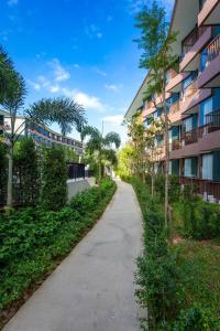 a walking path in front of a building at Wing 4206 - Modern Resort Studio Koh Samui in Bophut