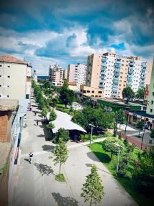 a city with tall buildings and a street with trees at Boulevard residence in Alba Iulia