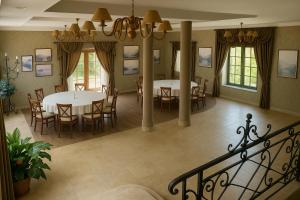 a dining room with two tables and chairs at Resort Klewinowo in Klewinowo