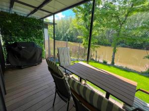 a patio with a table and chairs on a deck at MAX Dunaj in Trstice