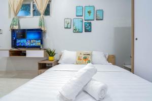 a bedroom with a white bed with towels on it at LalaHouse Pasteur in Ho Chi Minh City