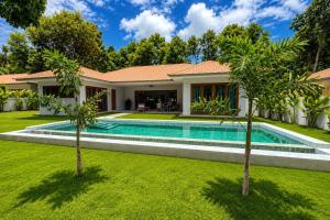 a house with a swimming pool in a yard at Tropical villa - Private pool - 3 bedrooms in Ko Phangan