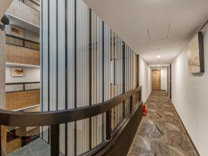 a corridor of a building with a staircase at Guide Hotel Taipei Fuxing North in Taipei
