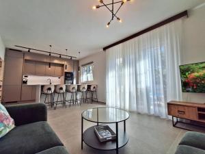 a living room with a couch and a table at Holiday house with pool and whirlpool Sara in Betina