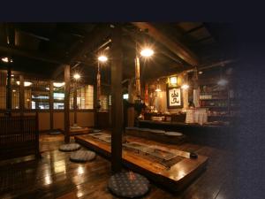 a room with a table in the middle of a building at Ryokan Yamanoyu in Minamioguni