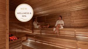 a woman sitting in a sauna with a man at Remisens Hotel Albatros-All inclusive in Cavtat +55 photos