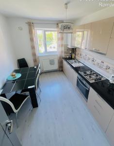 a kitchen with a table and a stove top oven at Boulevard residence in Alba Iulia
