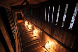 an overhead view of a wooden staircase with lights at Ryokan Yamanoyu in Minamioguni