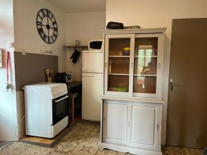 a kitchen with a white cabinet and a refrigerator at Appartement le Gallon in Langogne