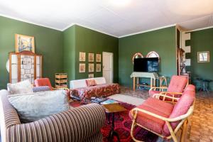 a living room with two couches and a tv at La Rochelle in Montagu