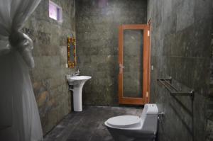 a bathroom with a toilet and a sink at Amed Romance House in Amed +110 photos