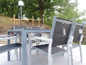 a group of blue chairs sitting next to each other at Nidus in Aulla