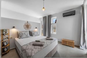 a bedroom with a bed with two towels on it at The Aer Element Of Gaea in Loutrá