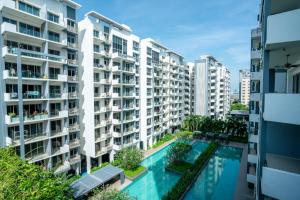 an apartment building with a swimming pool in the middle at Axis Residences By The Team in Phnom Penh