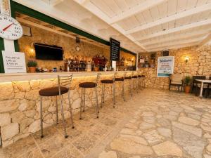 a bar with a row of stools in a restaurant at Aristomenis Studios in Vlachata