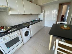 a kitchen with a sink and a washing machine at Diamante in Sorrento