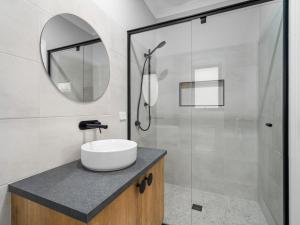 a bathroom with a sink and a shower at Central brand new studio in Beechworth