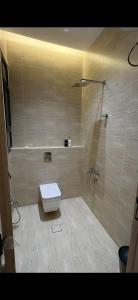 a bathroom with a toilet and a shower at Elite Stay in Buraydah