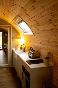 a kitchen with a sink and a skylight at The Fox at Snowhill Glamping in Scorton