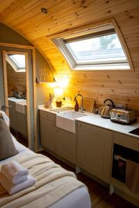 a kitchen with a sink and a window in a room at The Fox at Snowhill Glamping in Scorton