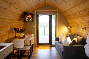 a living room with a couch and a table at The Fox at Snowhill Glamping in Scorton