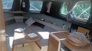 a living room with a couch and a table in an rv at Petit Shetland in Liverdun