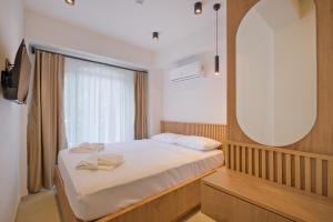 a small bedroom with a bed and a mirror at Miralya Downtown in Fethiye