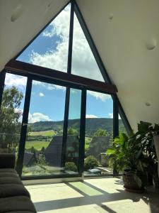 a large window in a living room with a view at Alva Rhön Panorama Ferienhaus - Auszeit mit Kamin in Frankenheim