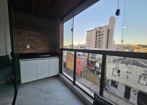 a balcony with a view of a city at Studio moderno no centro próximo a Academia e Cave in Juiz de Fora