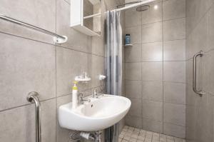 a bathroom with a sink and a shower at Jacobsdaller #1 in Jacobs Bay +6 photos