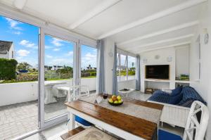 a living room with a table and a couch at Jacobsdaller #1 in Jacobs Bay