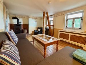 a living room with a couch and a table at Weiherhof in Ehrenberg