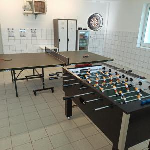 a room with two ping pong tables at Villa Kirnach Private Spa Retreat im Allgäu in Biessenhofen