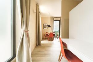 a living room with a table and chairs and a window at Miramare Apartments&Suites in La Spezia