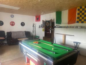 a living room with a pool table in it at Farrihy Hill House in Doonbeg