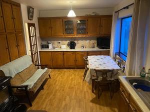 a kitchen with a table and a couch and a table at Farrihy Hill House in Doonbeg