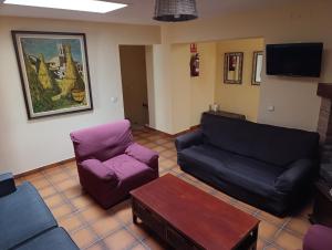 a living room with a couch and a chair at Mas Duran in La Pera