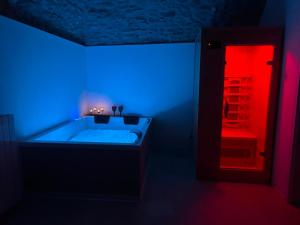 a bathroom with a tub with a blue and red light at AmarVite con spa privata in Dolceacqua +8 photos