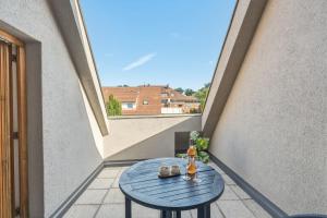 a blue table on a balcony with a window at Scharnhäusle 6 - wunderschönes Apartment mit Balkon in Ostfildern