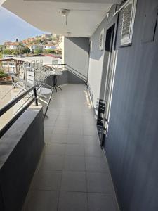 a balcony with a table and chairs on a building at ALİBABAM APART OTEL in Kuşadası