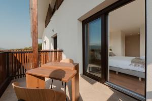 a room with a balcony with a bed and a table at Hotel Gamongoa in Rentería