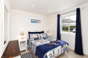 a bedroom with a bed and a window at Jacobsdaller #2 in Jacobs Bay