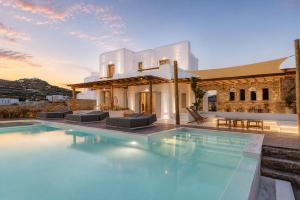 a villa with a pool in front of a building at Villa Yasemin - Mykonos Paradise - Views - Pool - Large Garden in Kalafatis +72 photos