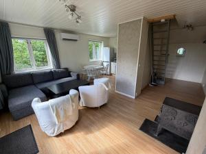 a living room with a couch and a table at Charming sea view in Bergen