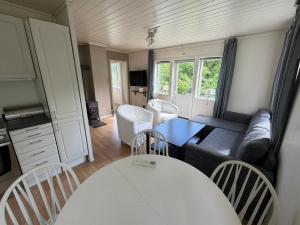 a living room with a couch and a table at Charming sea view in Bergen