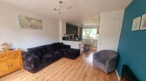 a living room with a couch and a chair at 78 Atlantic Reach in Newquay